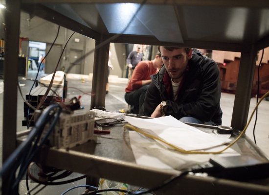 Electrical engineering major Jared Emerson works on programming the system during testing at the Freed Center.