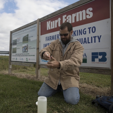 Christopher Spiese, associate professor of chemistry, collects water samples for nutrient analysis at one of the demonstration farm sites.
