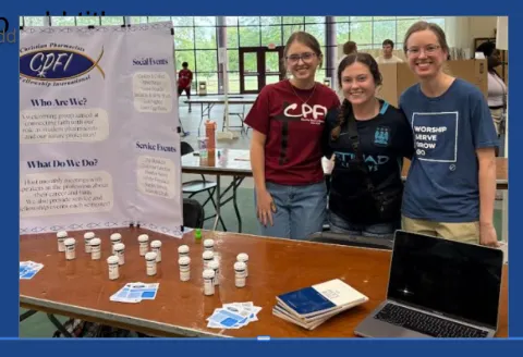 Members of CPFI at an informational table about Christian Pharmacist International.